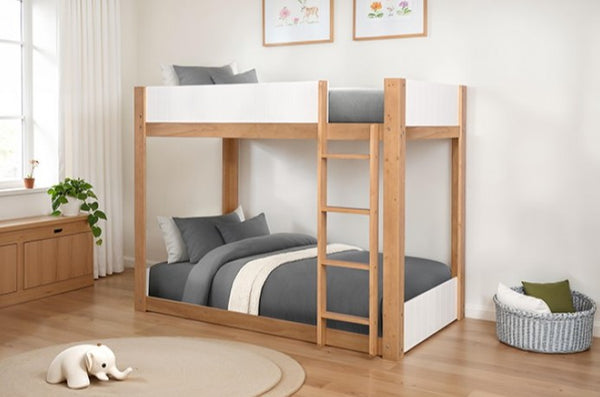Elia Twin Twin White Natural Low Bunkbed Wooden bunk bed with gray bedding in a room with a window, plant, and toy.
