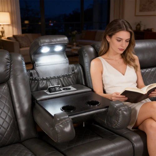 Eloise Power Gray Recliner Sectional Sofa LED Multi Color Lights Woman reading a book in a modern recliner chair with built-in entertainment system.