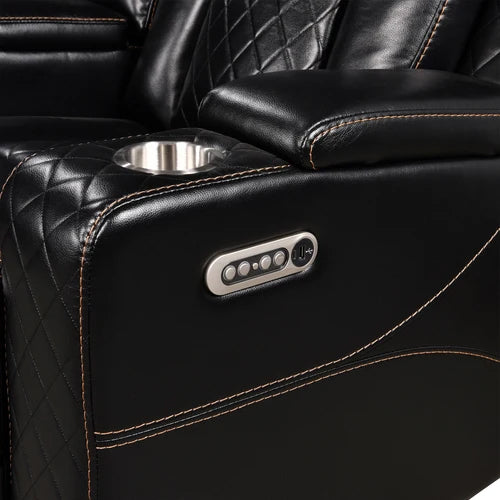 Eloise Power Recliner Sectional Sofa LED Multi Color Lights Close-up of a black leather recliner chair with diamond-quilted stitching, a side cup holder, and a silver control panel on the armrest.