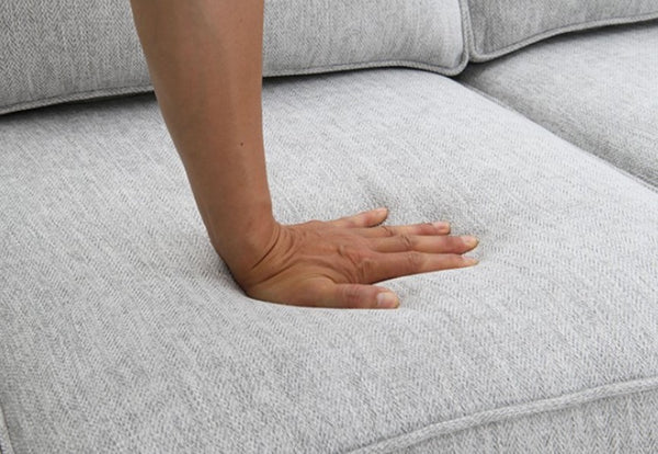 Erna Light Gray Chenille Fabric Sofa Hand resting on a light gray sofa
