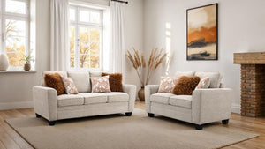 Erna Taupe Chenille Fabric Sofa Living room with two beige sofas, decorative pillows, and a fireplace.