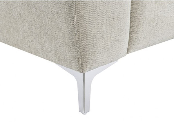 Estrella Light Taupe Brown Slope Flair Arm Chair Close-up of a light beige herringbone upholstered furniture corner with a slim silver metal leg on a white background.