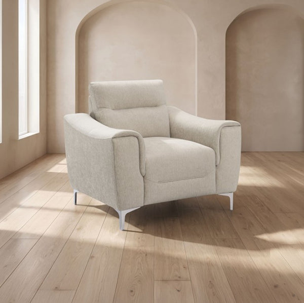 Estrella Light Taupe Brown Slope Flair Arm Chair A modern upholstered armchair in a light beige textured fabric, set in a minimalist room with beige walls, arched recesses, and light wood floors.