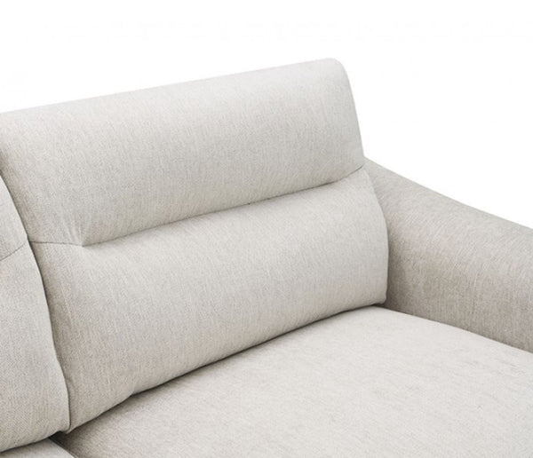 Estrella Light Taupe Brown Slope Flair Arm Loveseat Close-up of a light beige upholstered sofa showing the back cushion, armrest, and seat fabric against a plain white background.