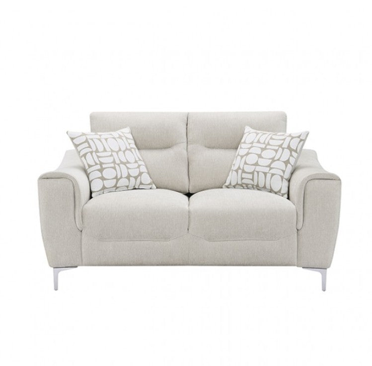 Estrella Light Taupe Brown Slope Flair Arm Loveseat A light beige upholstered loveseat with two patterned throw pillows, placed on a woven rug in a bright room with wood flooring and a window.