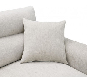 Estrella Light Taupe Brown Slope Flair Arm Loveseat A square light beige throw pillow with a textured linen-like fabric, resting on a matching light beige upholstered sofa against a plain white background.