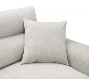 Estrella Light Taupe Brown Slope Flair Arm Sofa A square light beige throw pillow with a textured linen-like fabric, resting on a matching light beige sofa against a plain white background.
