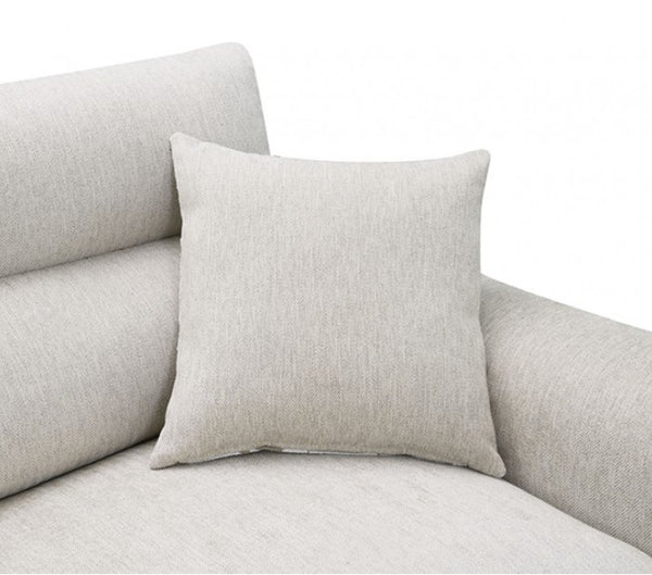 Estrella Light Taupe Brown Slope Flair Arm Sofa A square light beige throw pillow with a textured linen-like fabric, resting on a matching light beige sofa against a plain white background.