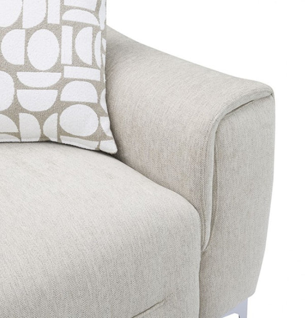 Estrella Light Taupe Brown Slope Flair Arm Sofa Close-up of a light beige upholstered sofa arm and seat with a patterned throw pillow featuring white geometric shapes on a taupe background.