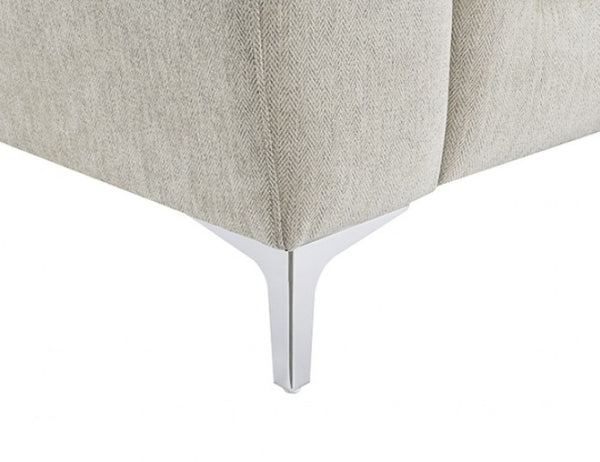 Estrella Light Taupe Brown Slope Flair Arm Sofa Close-up of a light beige herringbone fabric upholstered furniture corner with a polished silver metal leg on a white background.