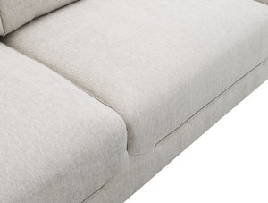 Estrella Light Taupe Brown Slope Flair Arm Sofa Close-up of a light beige textured fabric sofa cushion with clean stitching and a matching upholstered side arm, shown against a white background.