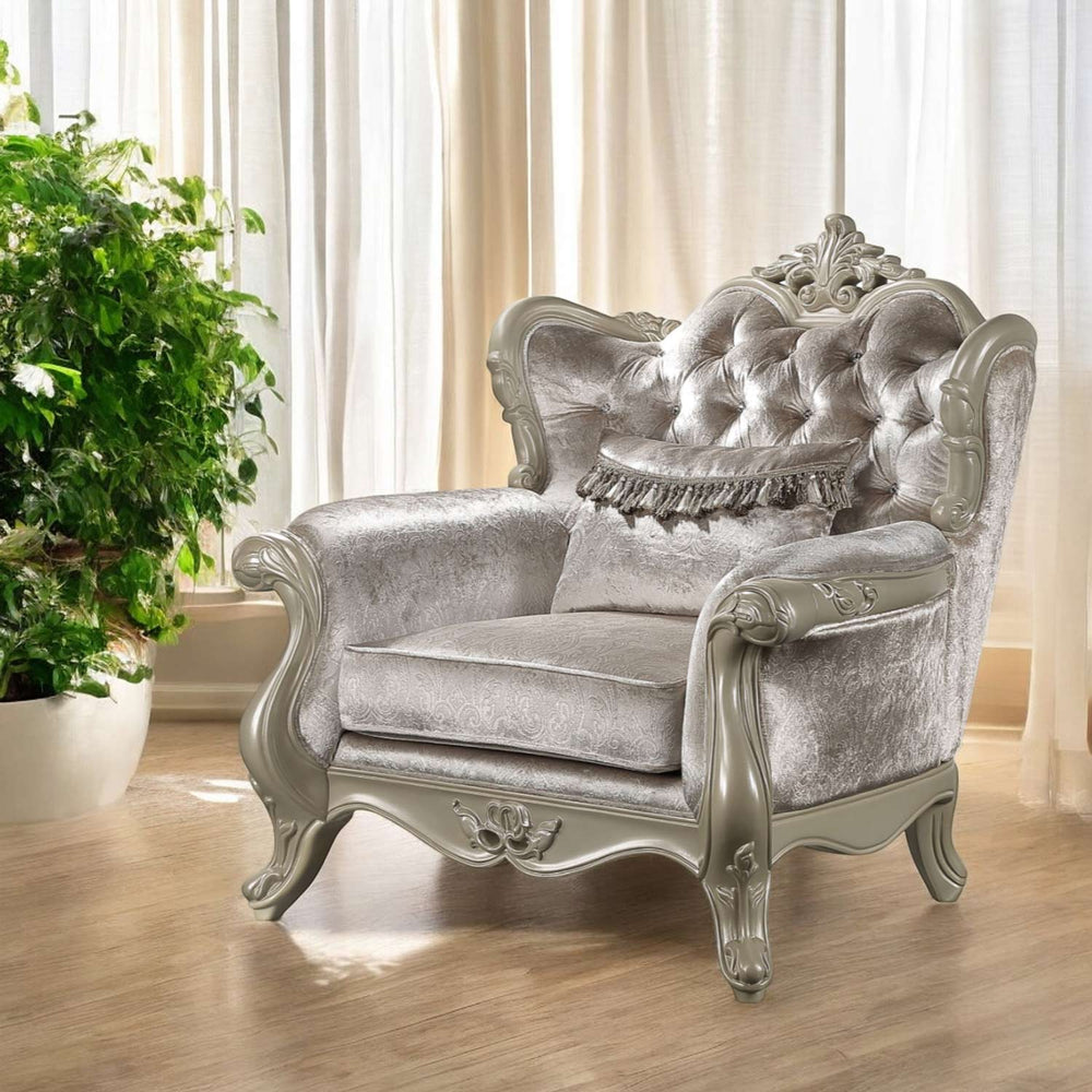 Ethaan Button Tufted Traditional Fabric Chair Silver ornate armchair in a room with white curtains and a plant.