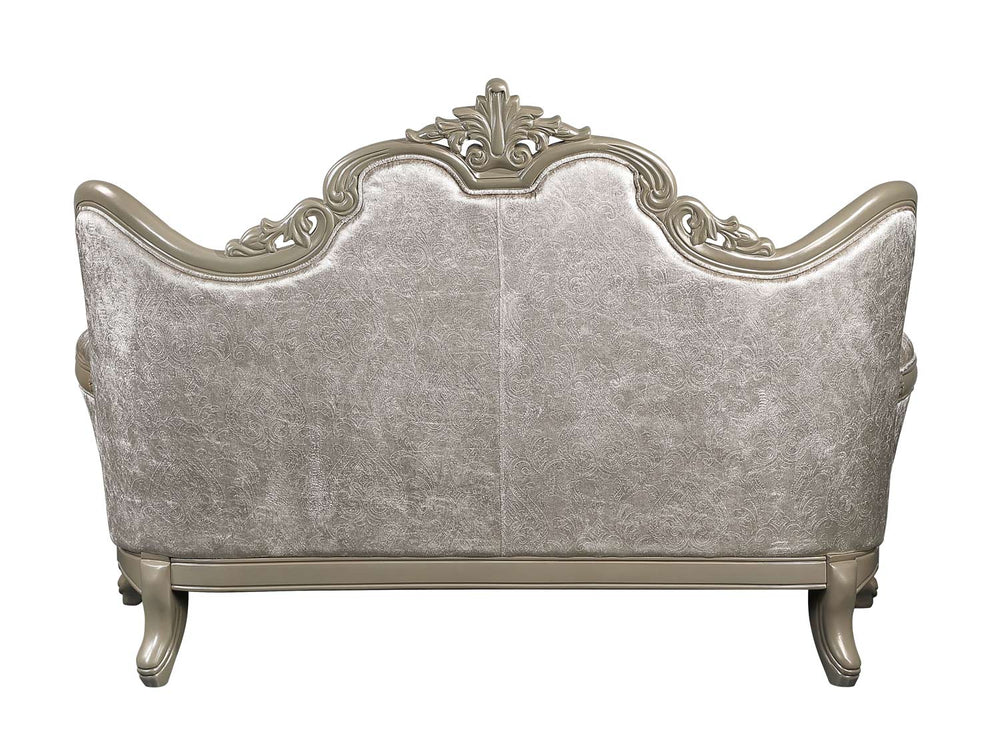 Ethaan Button Tufted Traditional Fabric Loveseat Decorative silver sofa with intricate designs in a room with beige walls and a plant.