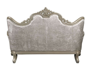 Ethaan Button Tufted Traditional Fabric Loveseat An ornate upholstered loveseat or sofa shown from the back, featuring a silver-gray textured velvet fabric and a carved light wood frame with decorative scrollwork and curved arms.