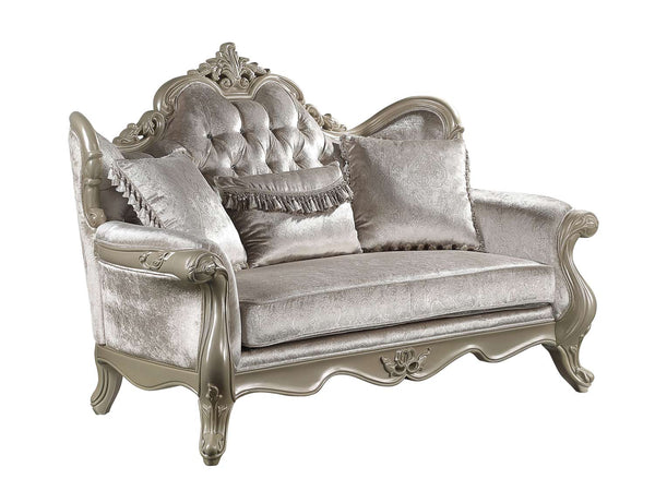 Ethaan Button Tufted Traditional Fabric Loveseat An ornate silver velvet loveseat with carved wood detailing, featuring a tufted backrest, three decorative throw pillows, and curved legs, shown on a plain white background.
