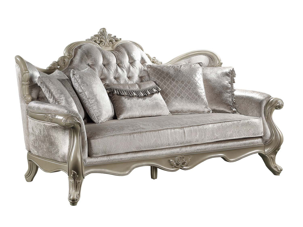 Ethaan Button Tufted Traditional Fabric Sofa A luxury French-style living room furniture set featuring a tufted sofa, two matching armchairs, and a carved coffee table, all in a silver and gray fabric with ornate silver frames, arranged on a gray rug in a grand room with green curtains.