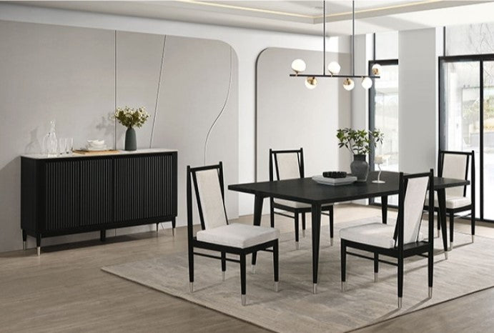 Dining room with a black table and chairs with white cushions in a modern interior.