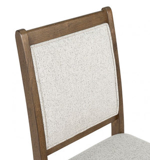 Ezera Dark Walnut Dining Chair Wooden chair with a textured white backrest on a white background