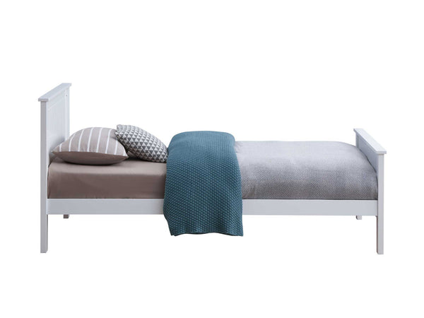 Gallow White Finish Twin Bed A white wooden single bed frame styled with a gray textured duvet, a brown sheet, a striped pillow, and a blue knit throw blanket, shown against a plain white background.