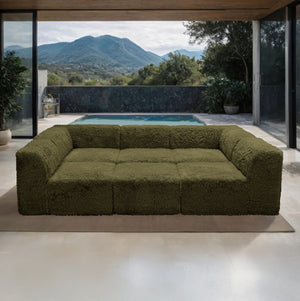 #Green Giacinto Compressed Foam Modern Daybed Green Finish Green textured sofa in a modern indoor setting with a pool and mountain view.
