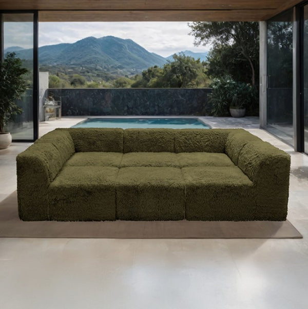 #Green Giacinto Compressed Foam Modern Daybed Green Finish Green textured sofa in a modern indoor setting with a pool and mountain view.