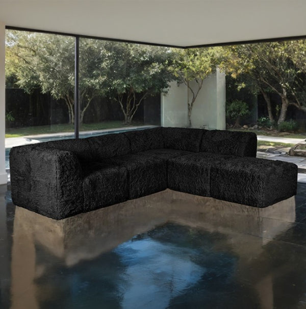 #Black  Giacinto Compressed Foam Modern L-Sectional Sofa Black Finish Black textured sectional sofa in a modern outdoor setting with trees and a pool.