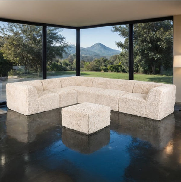 #sand  Giacinto Compressed Foam Modern L-Sectional Sofa Sand Finish Beige sectional sofa with ottoman in a modern living room with large windows showing a scenic view.
