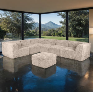 #Taupe  Giacinto Compressed Foam Modern L-Sectional Sofa Taupe Finish Beige sectional sofa with ottoman in a modern living room with large windows showing a scenic view.