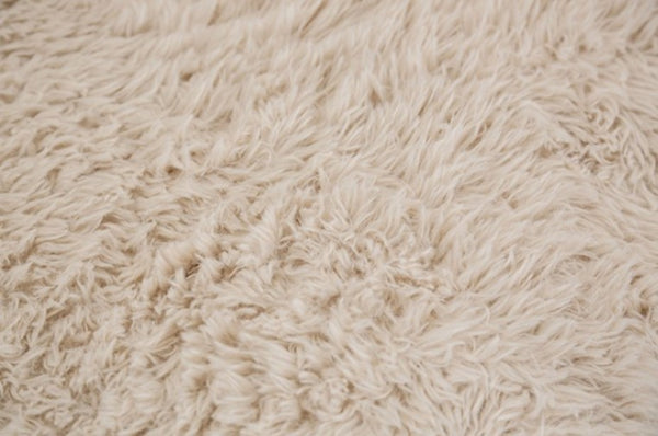 #sand  Giacinto Compressed Foam Modern L-Sectional Sofa Sand Finish Close-up of a beige, textured fabric surface