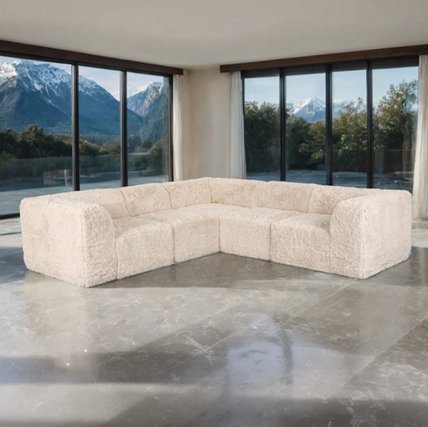 #sand  Giacinto Compressed Foam Modern L-Sectional Sofa Sand Finish Beige sectional sofa in a modern room with large windows and mountain views.