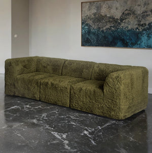 Giacinto Compressed Foam Modern Sofa Olive Green Finish Green textured sofa in a room with a marble floor and abstract painting on the wall.