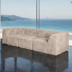 Giacinto Compressed Foam Modern Sofa Taupe Finish Beige sofa in a modern interior with large windows overlooking a blue ocean.