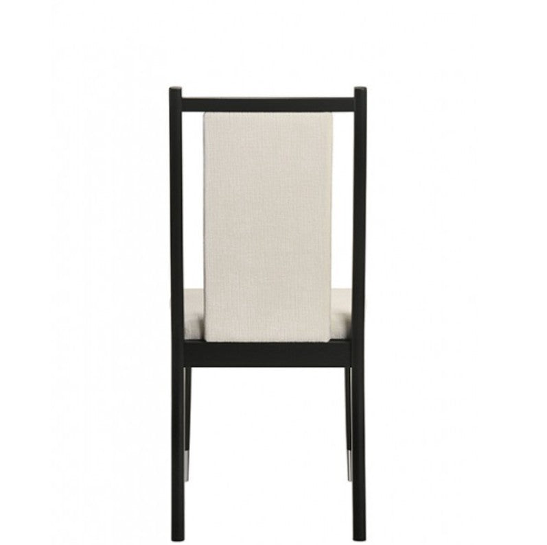 Grayson Contemporary Black White Fabric Chair Black dining chairs with cream upholstered seats and backrests, shown in a dining room setting next to a glass-top table.
