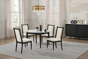 Grayson Contemporary Black White Fabric Chair A 5-piece dining set featuring a round white marble-top table with black legs and four matching high-back chairs with black frames and cream upholstered seats, shown in a bright dining room setting.
