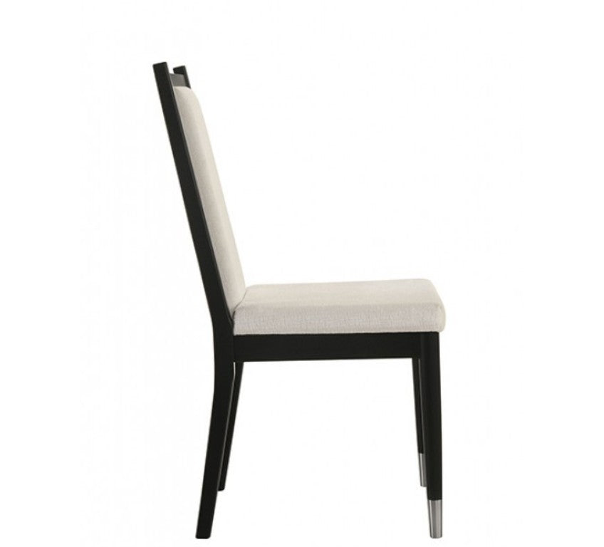 Grayson Contemporary Black White Fabric Chair Black dining chairs with cream upholstered seats and backrests, shown in a dining room setting next to a glass-top table.