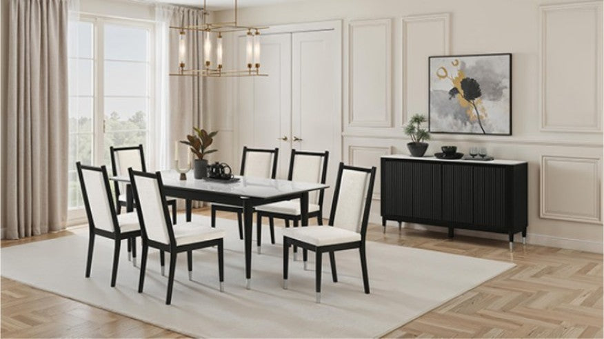 Grayson Contemporary Black White Sintered Stone Top Dining Table A 7-piece dining set featuring a rectangular table with a white marble-patterned top and black frame, surrounded by six matching chairs with black frames and off-white upholstered seats and backs, set in a bright dining room.