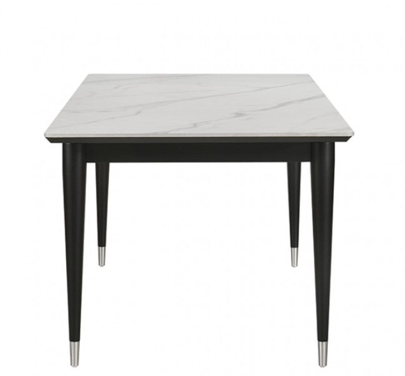 Grayson Contemporary Black White Sintered Stone Top Dining Table A 7-piece dining set featuring a rectangular table with a white marble-patterned top and black frame, surrounded by six matching chairs with black frames and off-white upholstered seats and backs, set in a bright dining room.