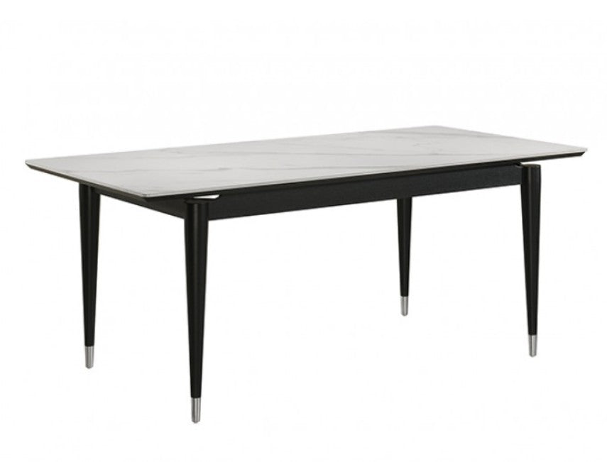 Grayson Contemporary Black White Sintered Stone Top Dining Table A 7-piece dining set featuring a rectangular table with a white marble-patterned top and black frame, surrounded by six matching chairs with black frames and off-white upholstered seats and backs, set in a bright dining room.