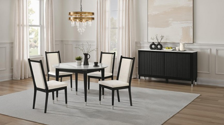 Grayson Contemporary Black White Sintered Stone Top Round Dining Table A round dining table with a white marble-look top and black legs, surrounded by five matching chairs with cream upholstered seats and black frames, set on a light gray rug in a bright dining room.