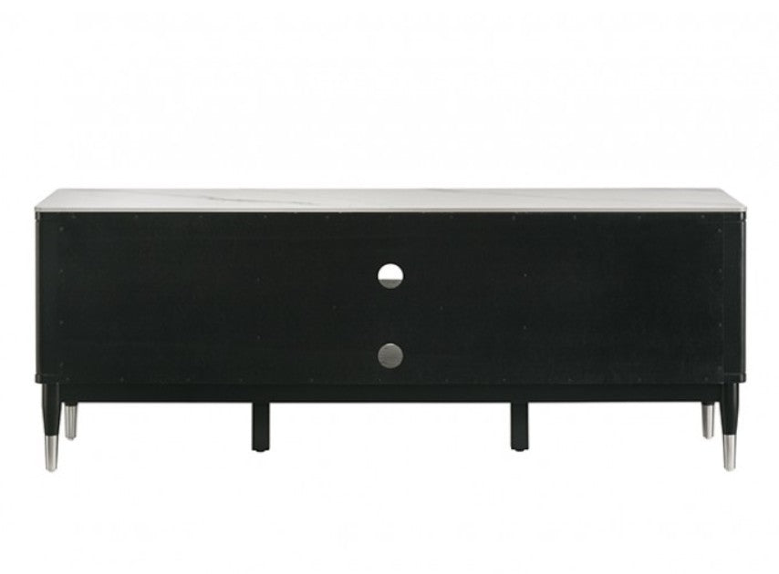 Grayson Contemporary Black White Sintered Stone Top TV Console A modern black TV stand with a white marble-look top and silver metal legs, shown in a styled living room setting with a wall-mounted TV, decorative vases, and a patterned rug.