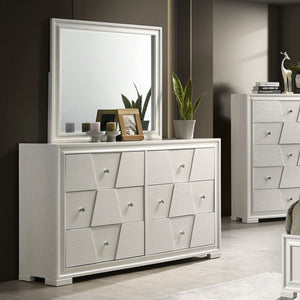 Hailly Trapezoid Dresser With White Finish White dresser with geometric drawer design in a room setting.
