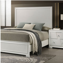 Hailly Trapezoid Panel Bed With White Finish Bedroom with a bed and nightstand featuring neutral colors.