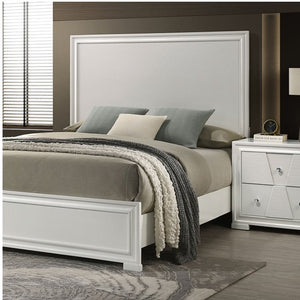 Hailly Trapezoid Panel Bed With White Finish Bedroom with a bed and nightstand featuring neutral colors.