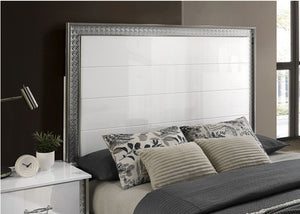 Hailry Glam Modern High Gloss White Finish Bed Bedroom with a bed featuring decorative pillows and a metallic headboard.