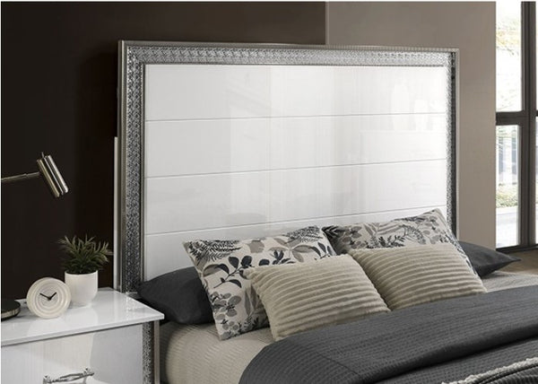 Hailry Glam Modern High Gloss White Finish Bed Bedroom with a bed featuring decorative pillows and a metallic headboard.
