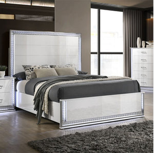 Hailry Glam Modern High Gloss White Finish Bed Modern bedroom with a bed featuring a decorative headboard and gray bedding.