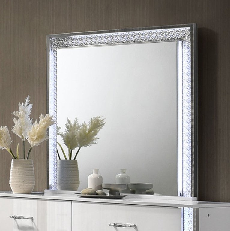 Hailry Glam Modern High Gloss White Finish Mirror Decorative mirror with a crystal frame on a wall above a white cabinet with decorative items.