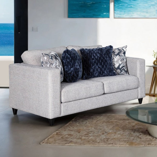 Harrold Light Gray Transitional Style Loveseat Gray sofa with decorative pillows in a living room setting with ocean view