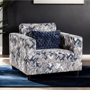 Harrold Light Gray Transitional Style Chair Patterned armchair with a textured blue pillow on a dark gray wall background