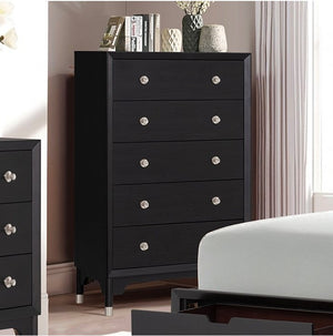Hermin Modern Style Chest Black Black dresser with silver knobs in a bedroom setting